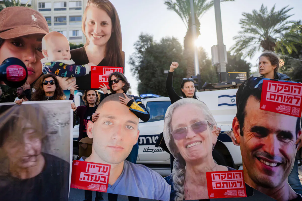 Relatives and supporters of Israeli hostages held by Hamas in the Gaza Strip hold photos of their loved ones during a protest calling for their return, in Tel Aviv, Israel, on Jan. 8, 2025. (AP Photo/Ohad Zwigenberg)