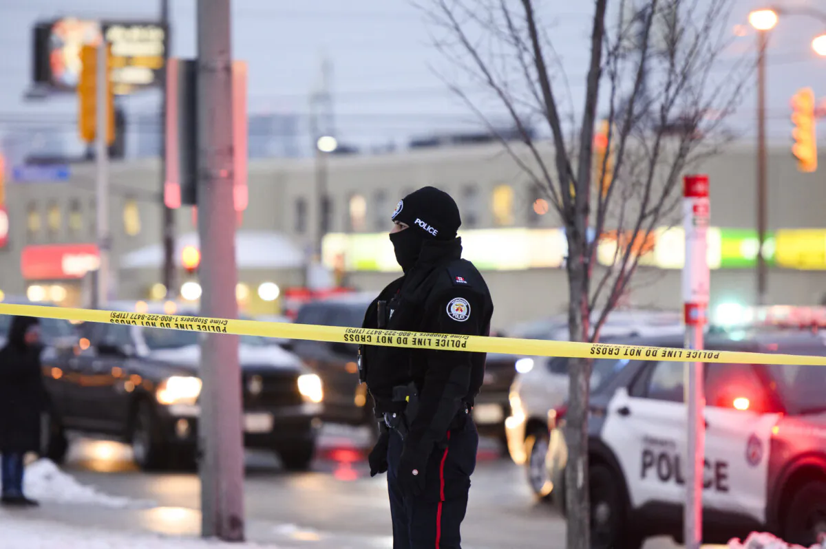 Police secure a crime scene near Northview Heights Secondary School in Toronto on Jan. 22, 2024, after at least one person was injured and a suspect was reportedly seen carrying a machete in the neighbourhood. (The Canadian Press/Christopher Katsarov)
