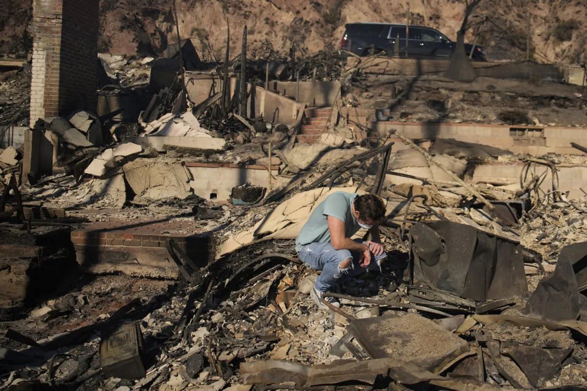 A man sifts through the remains of his family's fire-ravaged beachfront property in the aftermath of the Palisades Fire, in Malibu, Calif., on Jan. 10, 2025. (John Locher/AP Photo)