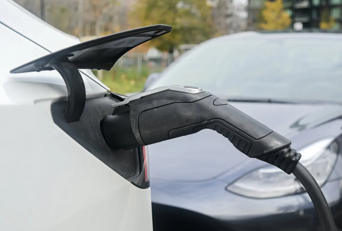 An electric vehicle being charged on a street in Montreal, on Nov. 5, 2024. (The Canadian Press/Graham Hughes)
