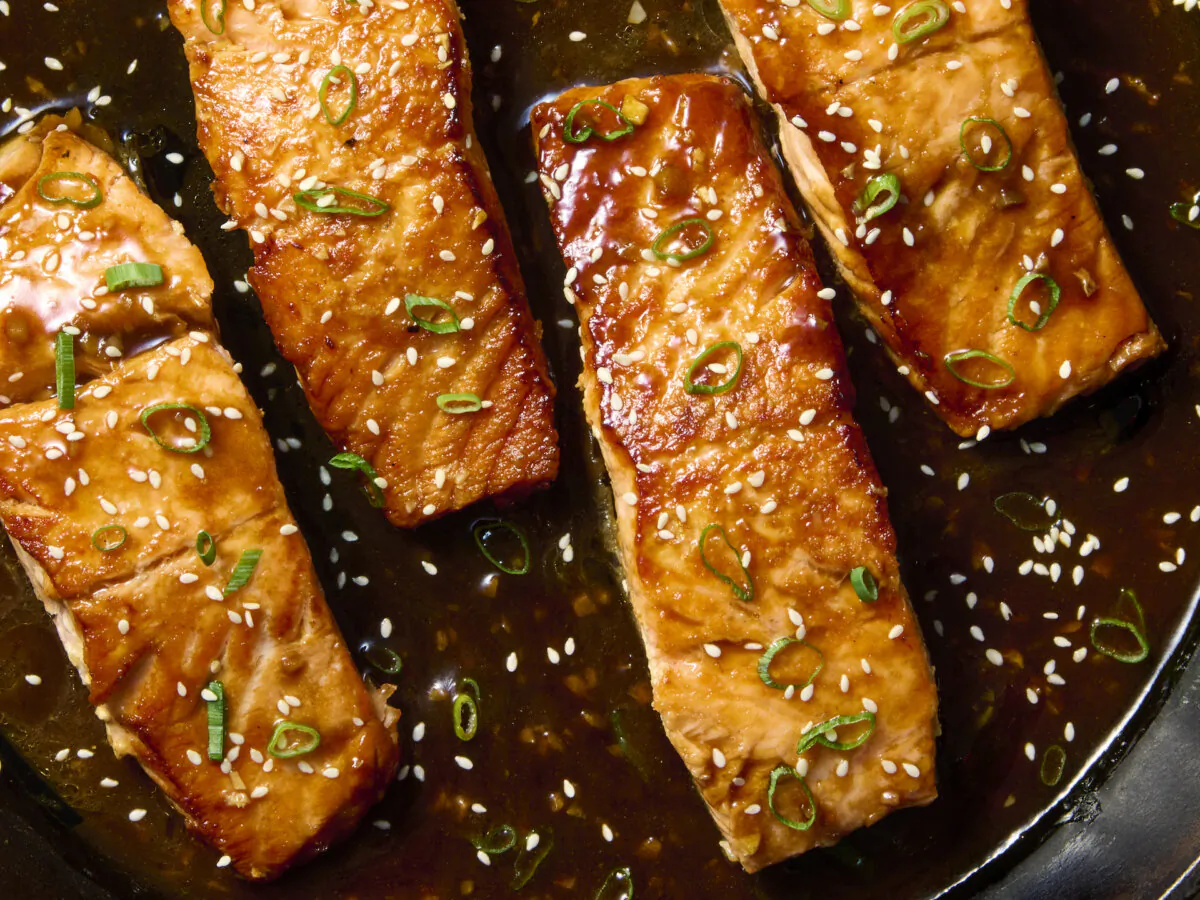 Hoisin sauce and a few pantry ingredients transform into a sticky glaze to baste over the salmon as it cooks. (Alex Lepe/TCA)