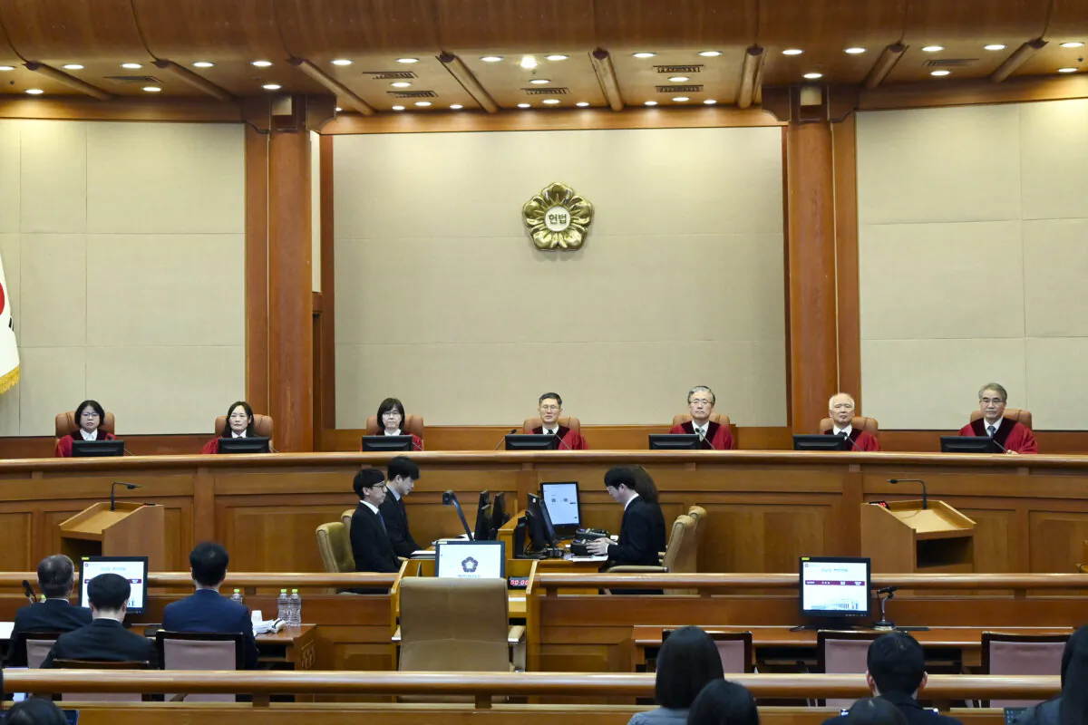 (L-R) Constitutional Court Judges Chung Kye-sun, Kim Bok-hyeong, Jung Jung-mi, Lee Mi-son, acting head of the Constitutional Court Moon Hyung-bae, Kim Hyung-du, Cheong Hyung-sik and Cho Han-chang attend the first formal hearing of the impeachment trial of suspended South Korean President Yoon Suk Yeol at the Constitutional Court in Seoul on Jan. 14, 2025. (Kim Min-Hee/AFP via Getty Images)