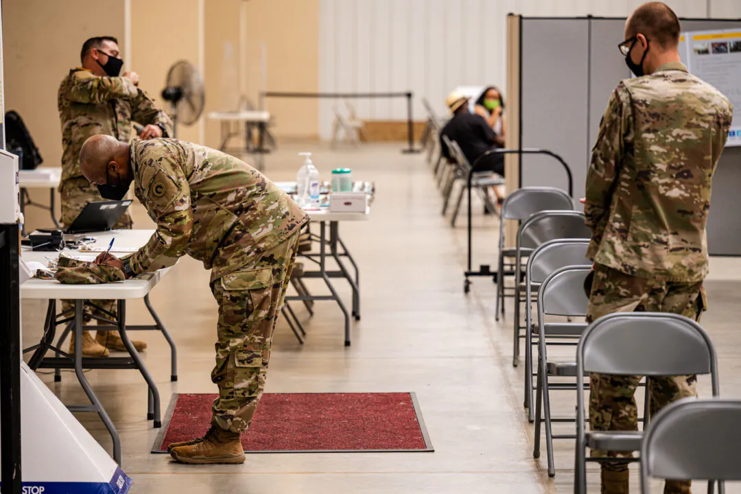 Soldiers file paperwork before receiving COVID-19 vaccines in Fort Knox, Ky., on Sept. 9, 2021. (Jon Cherry/Getty Images)