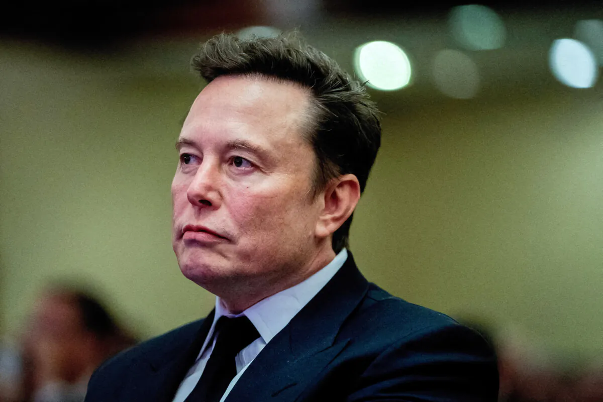 Tesla CEO and X owner Elon Musk listens as President-elect Donald Trump speaks during a meeting with House Republicans at the Hyatt Regency hotel in Washington on Nov. 13, 2024. (Allison Robbert/Reuters)