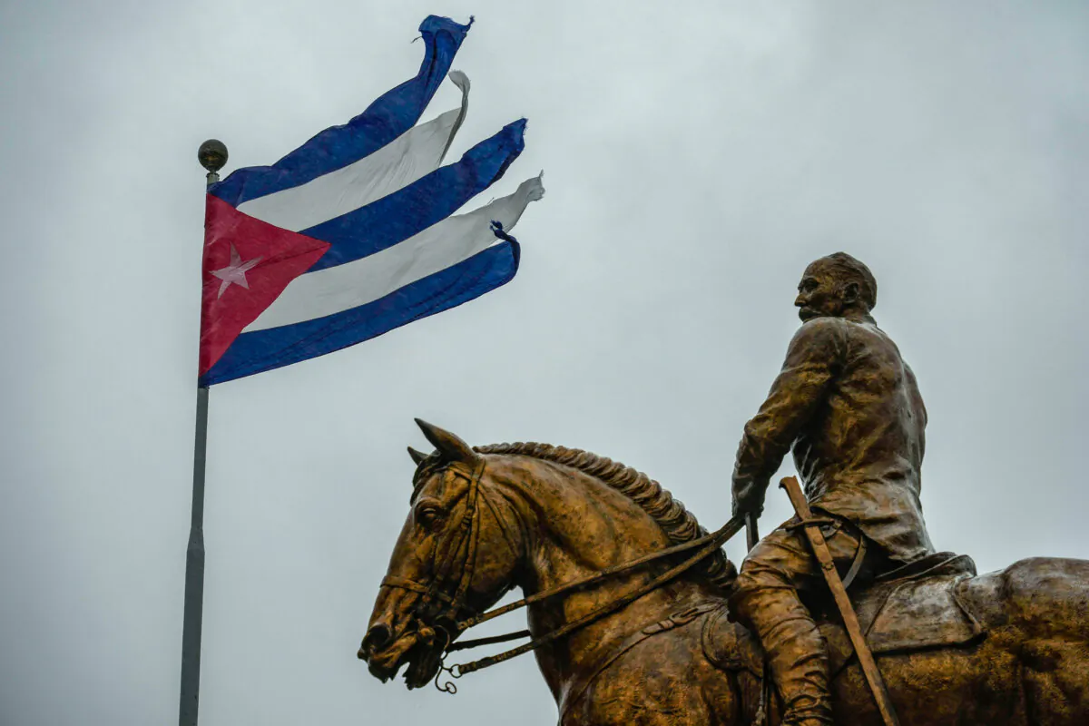 A Cuban flag shredded by the winds of Hurricane Rafael flies above the statue of Gen. Calixto Garcia in Havana on Nov. 6, 2024. (Ramon Espinosa/AP Photo)