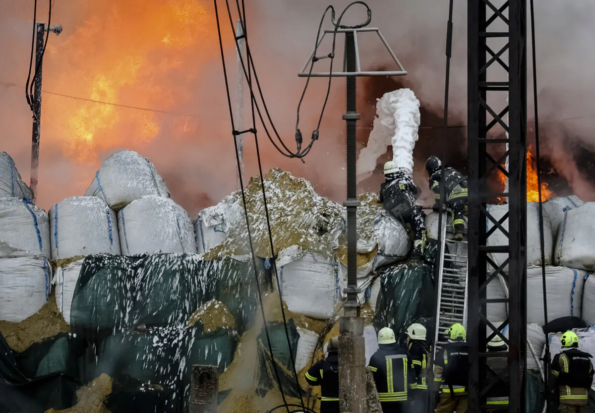 Firefighters work at a site of a power infrastructure object, which was hit during Russia's missiles strike, outside Kharkiv, Ukraine, on March 22, 2024. (Sofiia Gatilova/Reuters)