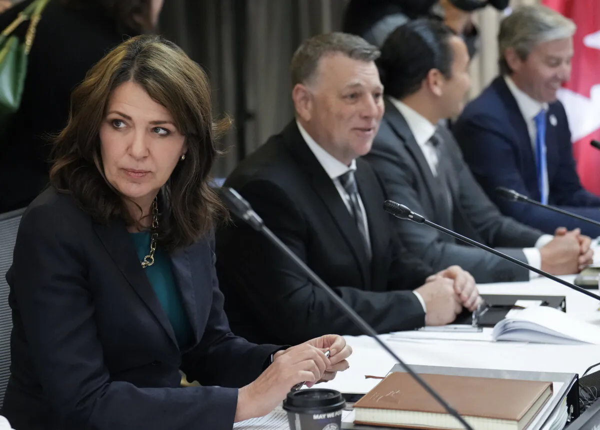 Alberta Premier Danielle Smith talks with colleagues during the fall meetings of Canada's premiers hosted by Ontario in Toronto on Dec. 16, 2024. (Nathan Denette/The Canadian Press)