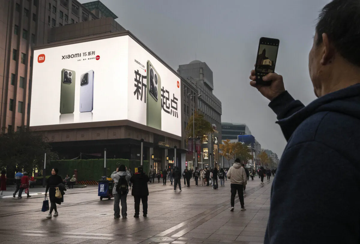 An electronic billboard shows an ad for Chinese smartphone maker Xiaomi on a building in a popular shopping area in Beijing, on Nov. 8, 2024. (Kevin Frayer/Getty Images)