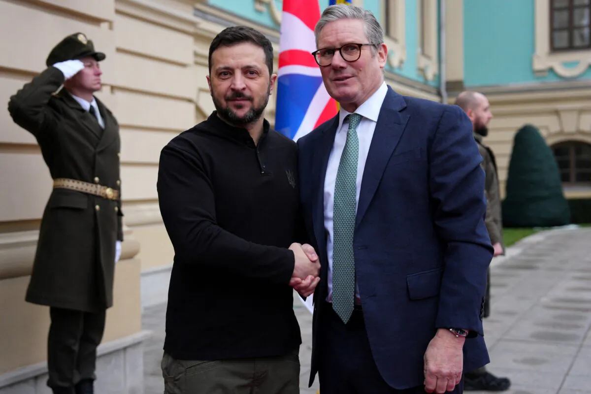Britain's Prime Minister Sir Keir Starmer (R) shakes hands with Ukrainian President Volodymyr Zelenskyy upon his arrival for a meeting in Kyiv on Jan. 16, 2025. (Carl Court/Pool/AFP via Getty Images)