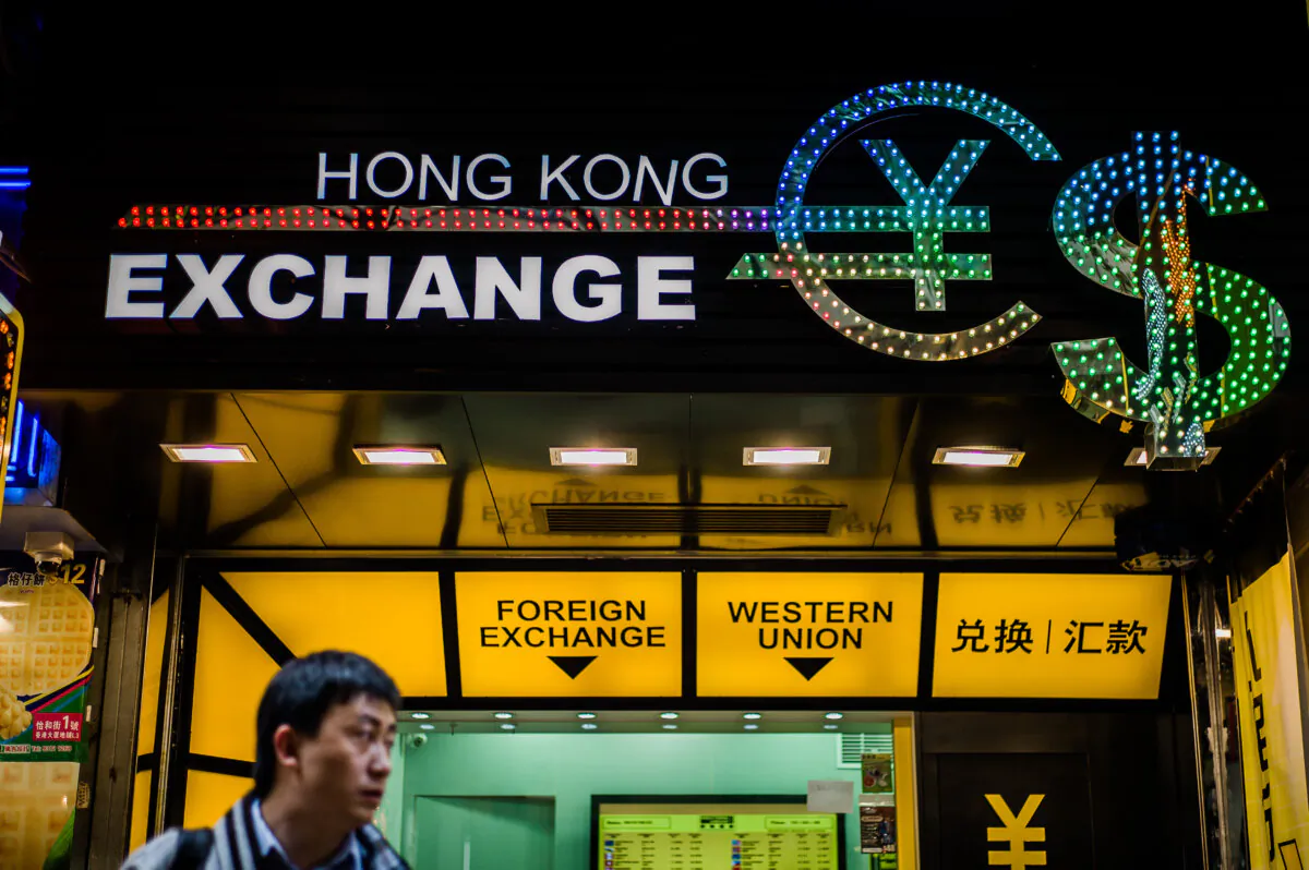 A man looks on in front of a currency exchange booth in Hong Kong on Oct. 22, 2012. (Philippe Lopez/AFP via Getty Images)