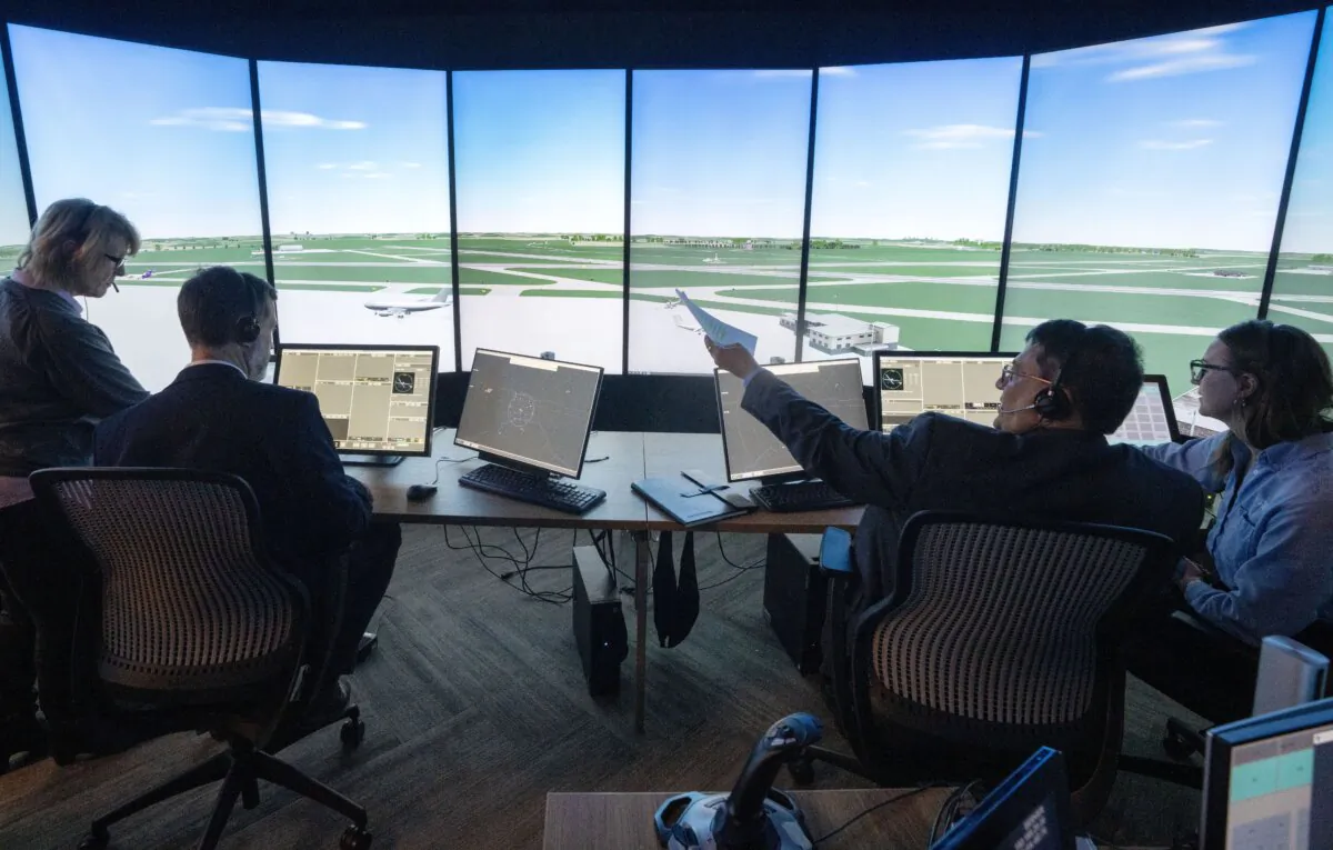 Instructor Karina Vasylenko, front, shows media how the air traffic control simulator works at the CAE training facility in Montreal, on Jan. 14, 2025. (The Canadian Press/Ryan Remiorz) 
