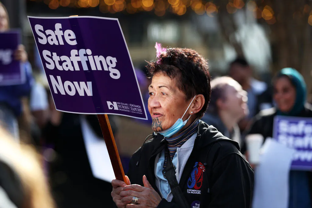 Nurses march in protest along Queen St in Auckland, New Zealand on June 9, 2021. (Fiona Goodall/Getty Images)