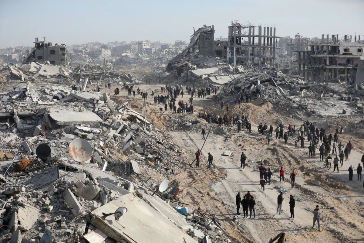 Displaced Palestinians walk past the rubble as they attempt to return to their homes in the northern Gaza Strip, on Jan. 19, 2025. (Dawoud Abu Alkas/Reuters)