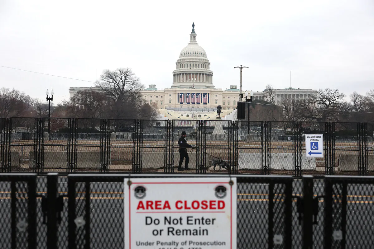 A Capitol police officer sweeps the area outside the U.S. Capitol with a police dog the day before President-elect Donald Trump's 2nd term inauguration, in Washington on Jan. 19, 2025. (Joe Raedle/Getty Images)