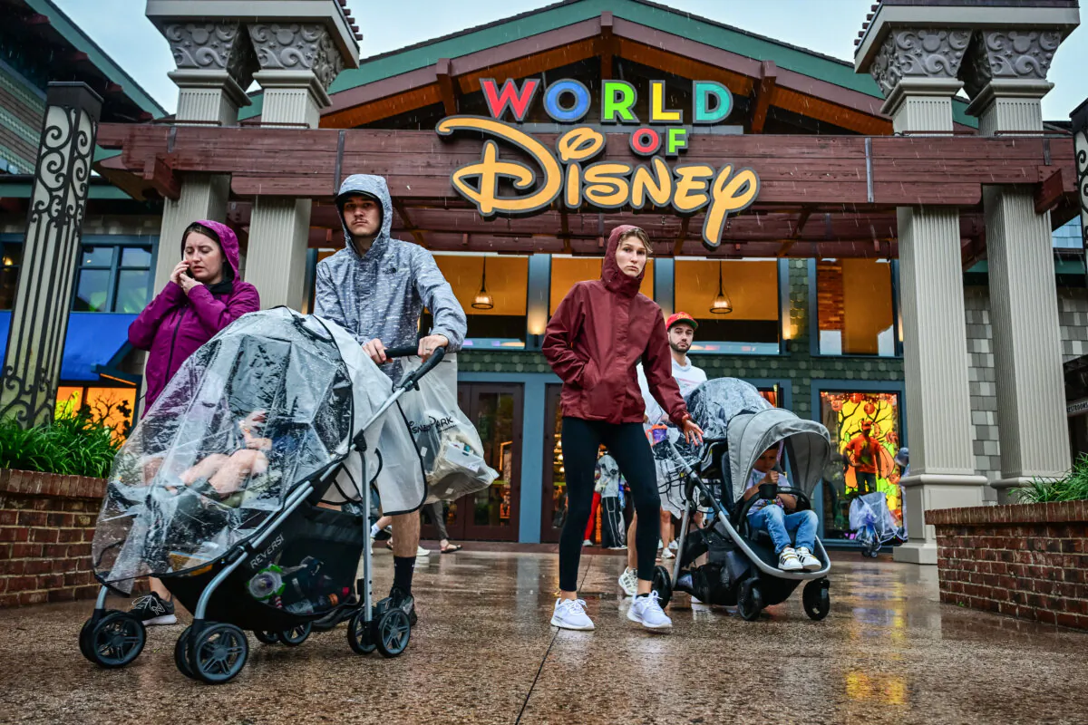 Visitors walk through the Disney Springs shopping center in Orlando, Fla., on Oct. 9, 2024. (Giorgio Viera/AFP via Getty Images)