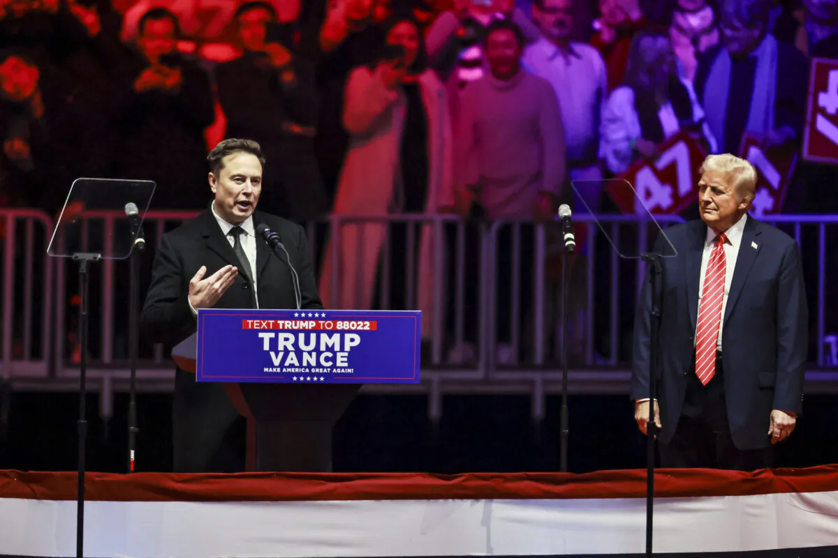 Elon Musk, CEO and chief engineer of SpaceX, speaks as President-elect Donald Trump looks on at the Make America Great Again Victory Rally at Capital One Arena one day before his inauguration in Washington on Jan. 19, 2025. (John Fredricks/The Epoch Times)