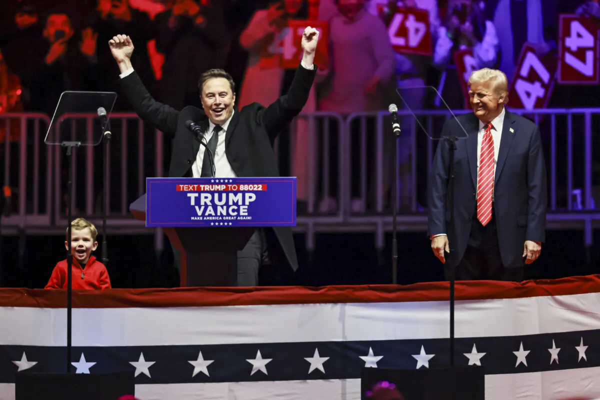 Elon Musk, CEO and Chief Engineer of SpaceX, arrives with his son X on stage with President-elect Donald Trump at the Make America Great Again Victory Rally at Capital One Arena one day prior to his Inauguration in Washington on Jan. 19, 2025. (John Fredricks/The Epoch Times)