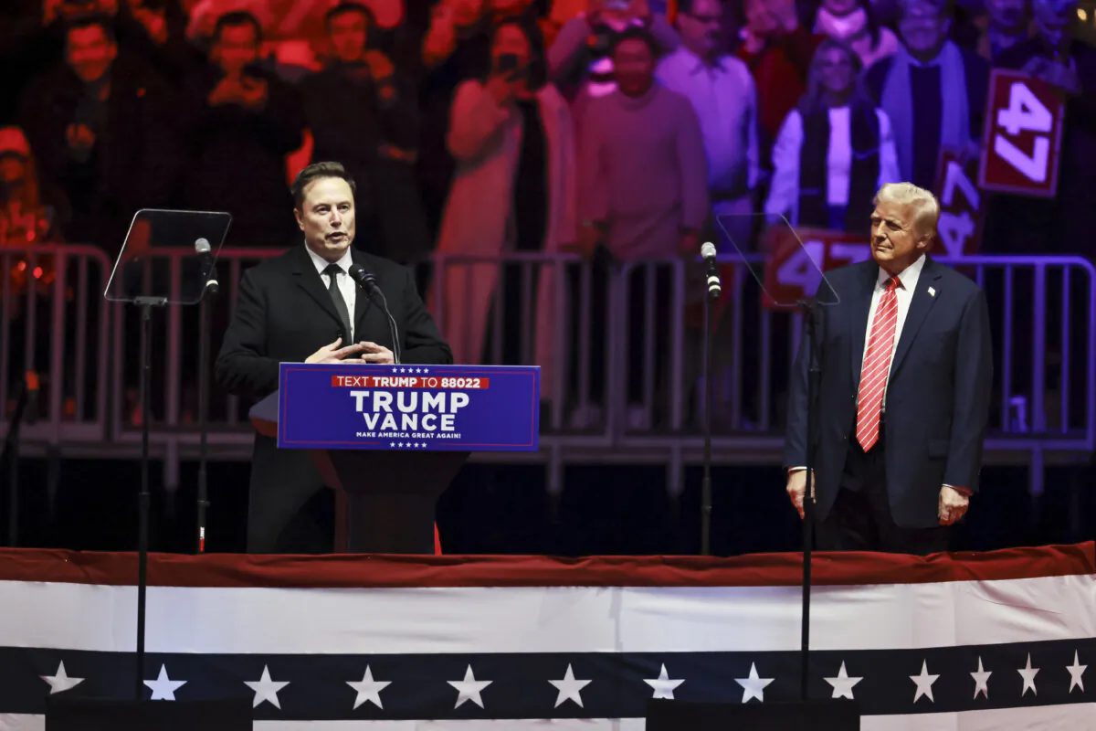 Elon Musk, CEO and Chief Engineer of SpaceX, speaks as President-elect Donald Trump looks on at the Make America Great Again Victory Rally at Capital One Arena one day prior to his Inauguration in Washington on Jan. 19, 2025. (John Fredricks/The Epoch Times)