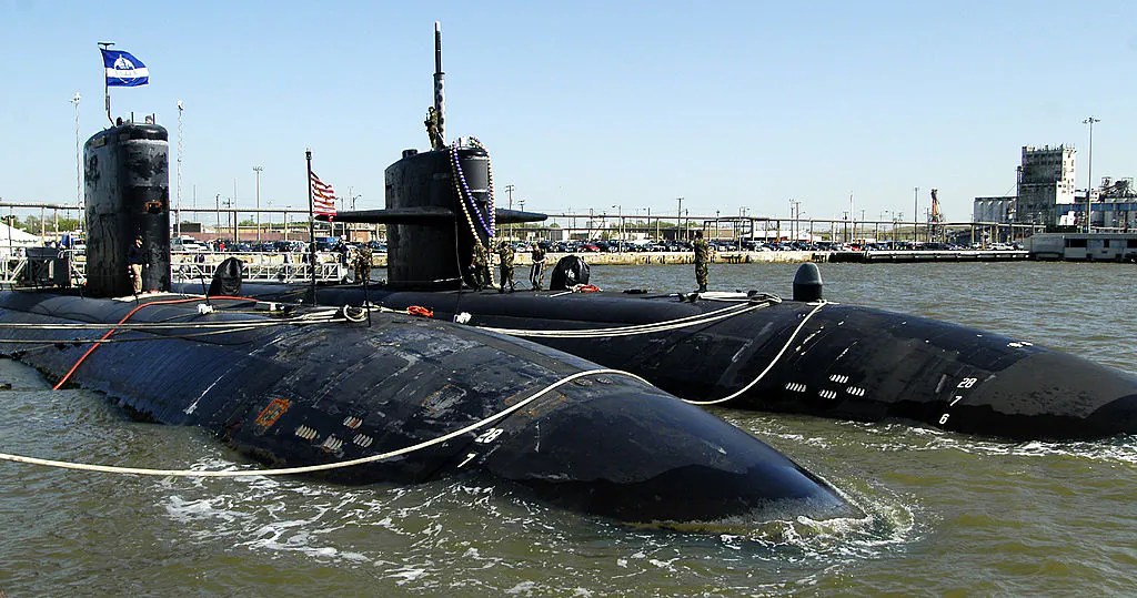 The USS Newport News (R) secures itself next to its sister Los Angeles-class submarine USS Boise (L) after returning to Norfolk Naval Station in Norfolk, Virginia, on April 23, 2003. (Mike Heffner/Getty Images)