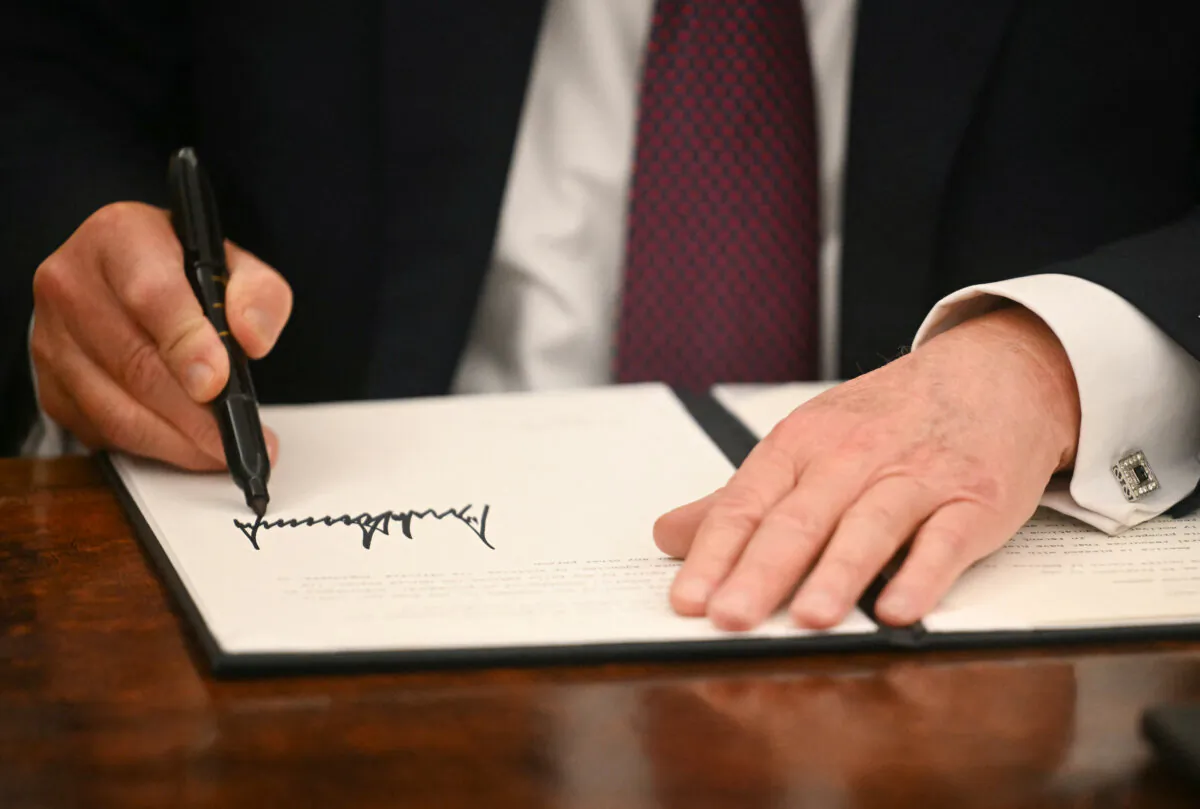 President Donald Trump signs executive orders in the Oval Office of the WHite House on Jan. 20, 2025. (Jim Watson/Pool/AFP via Getty Images)