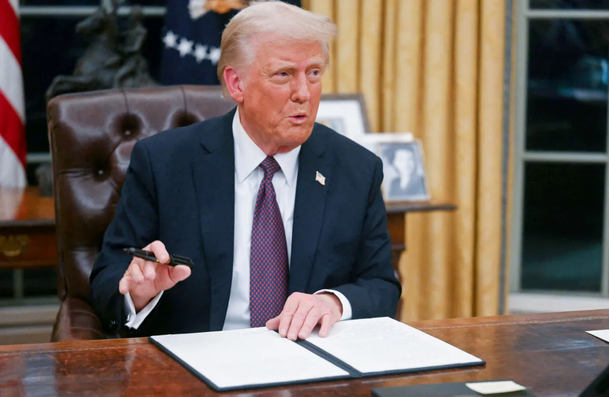 President Donald Trump signs an executive order to withdraw the United States from the World Health Organization, in the Oval Office of the White House on Jan. 20, 2025. (Jim Watson/POOL/AFP via Getty Images)