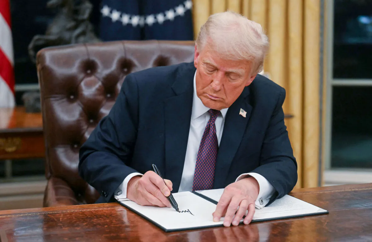 President Donald Trump signs an executive order to withdraw the United States from the World Health Organization, in the Oval Office of the White House in Washington on Jan. 20, 2025. (Jim Watson/POOL/AFP via Getty Images)