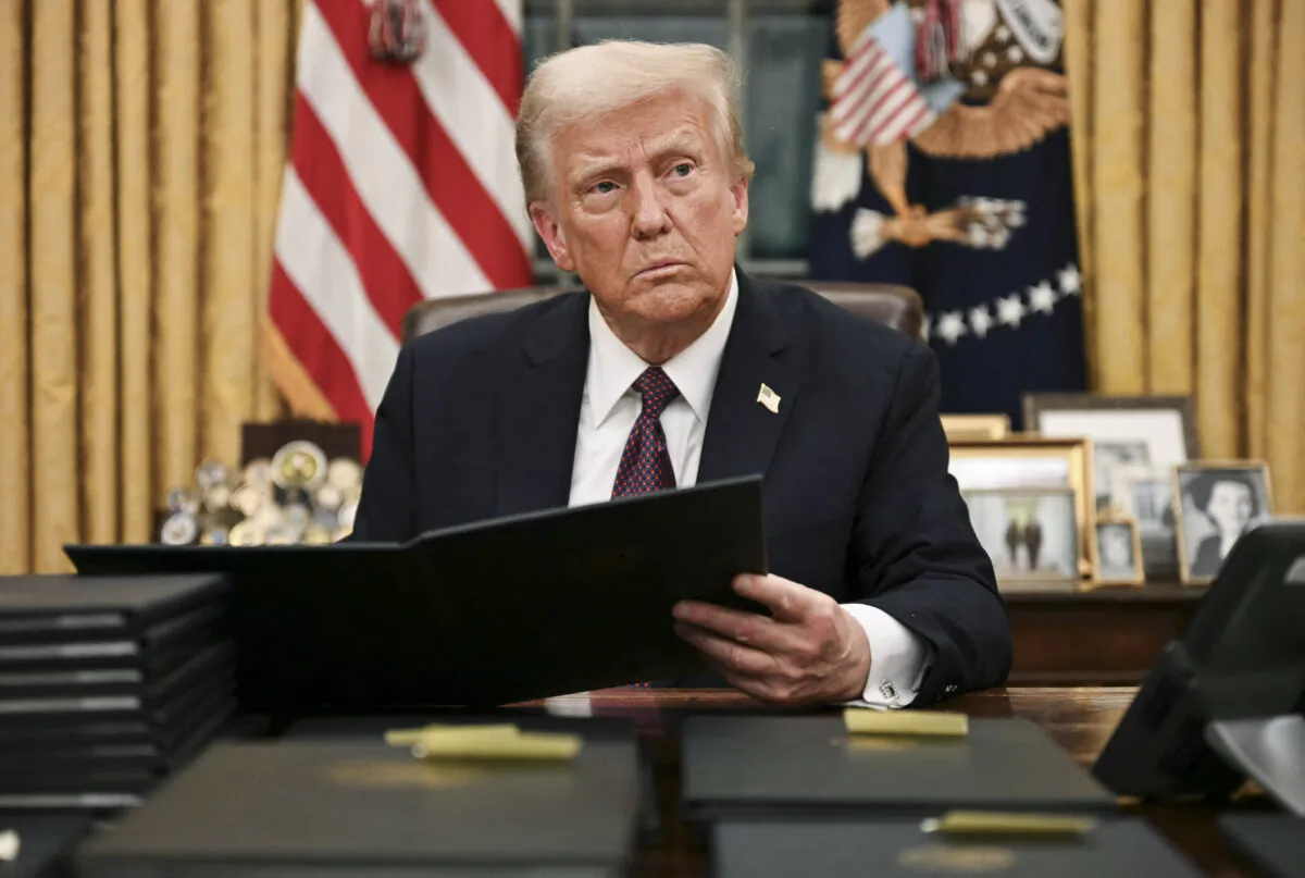 President Donald Trump signs an executive order in the Oval Office of the White House, on Jan. 20, 2025. (Jim Watson/AFP via Getty Images)