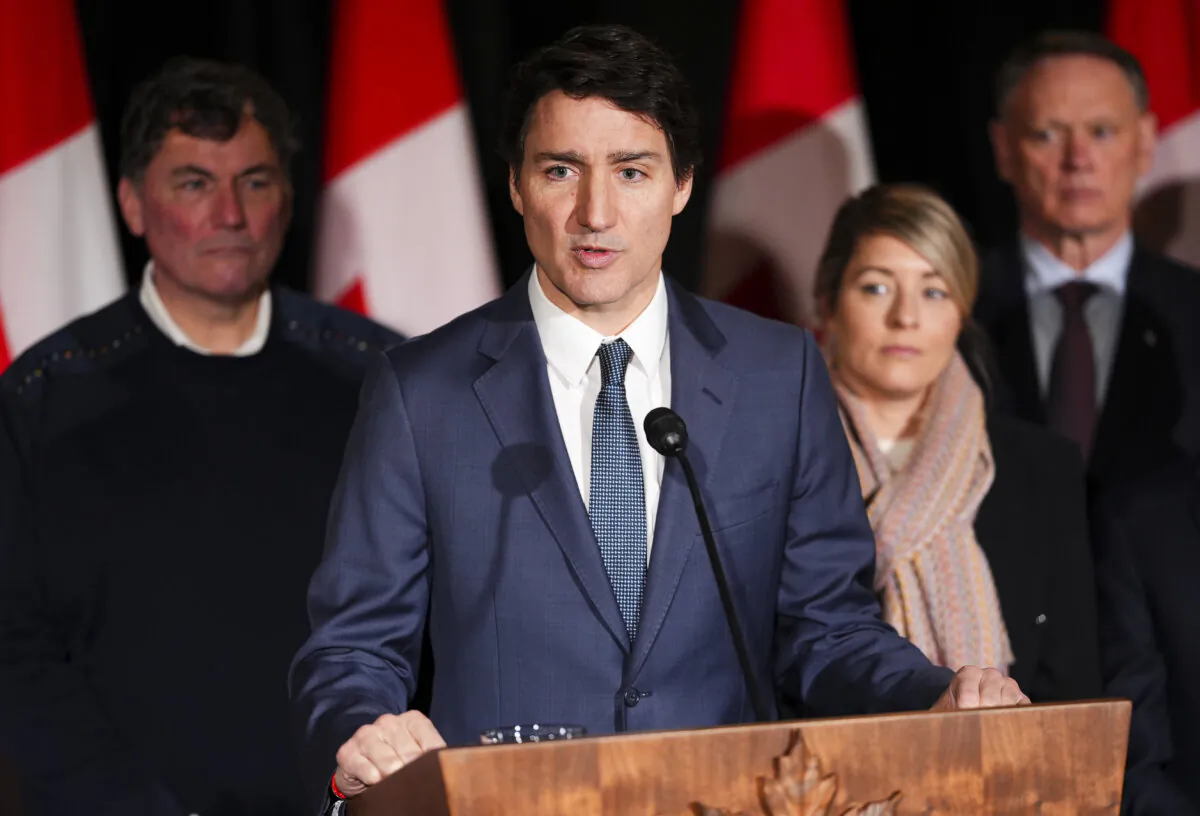 Prime Minister Justin Trudeau is flanked by (L-R) Minister of Finance Dominic LeBlanc, Minister of Foreign Affairs Melanie Joly, and Minister of Public Safety David McGuinty, as he holds a press conference during a cabinet retreat at Chateau Montebello in Montebello, Que., on Jan. 21, 2025. (Sean Kilpatrick/The Canadian Press)