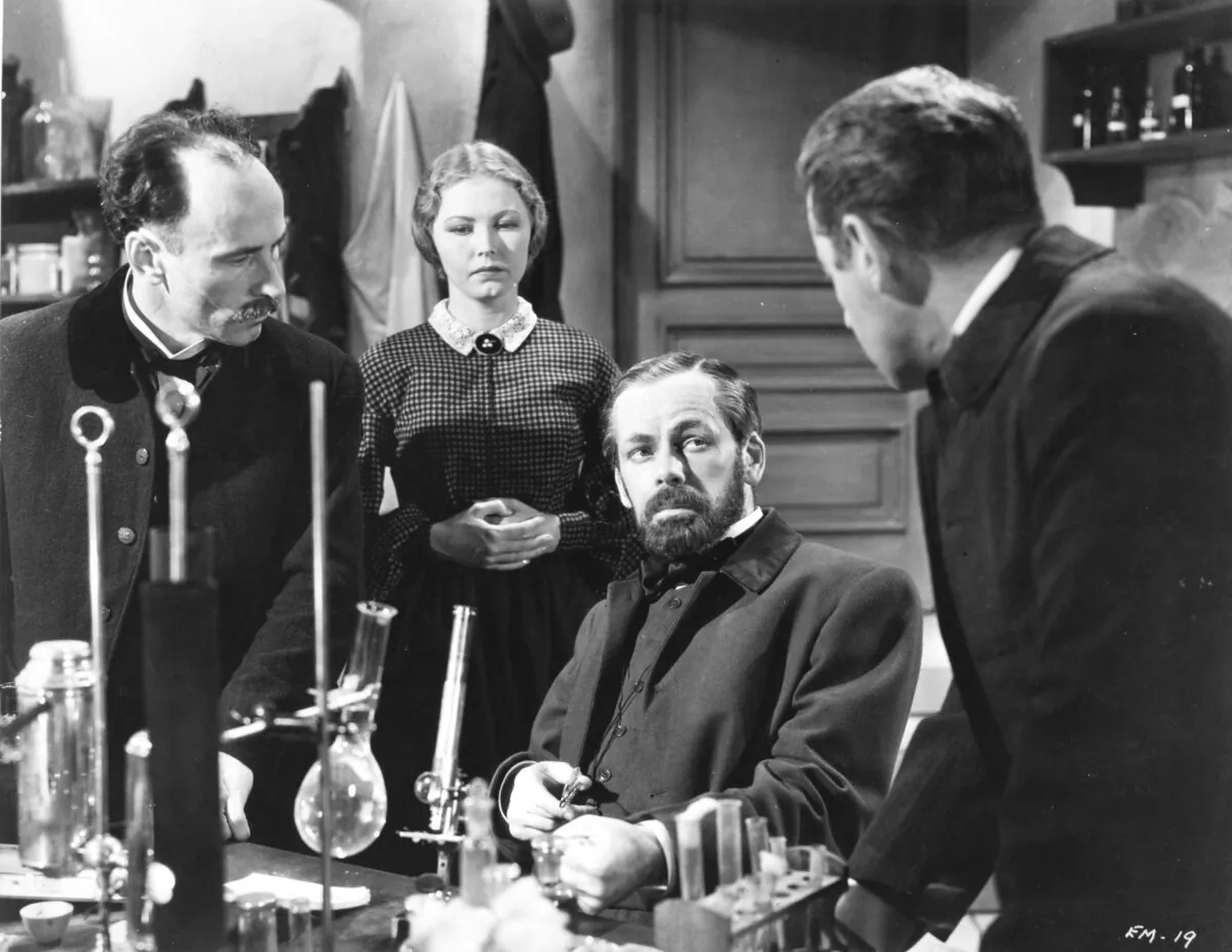 Louis Pasteur (Paul Muni, C) researches the value of vaccines, in "The Story of Louis Pasteur." (Warner Bros)
