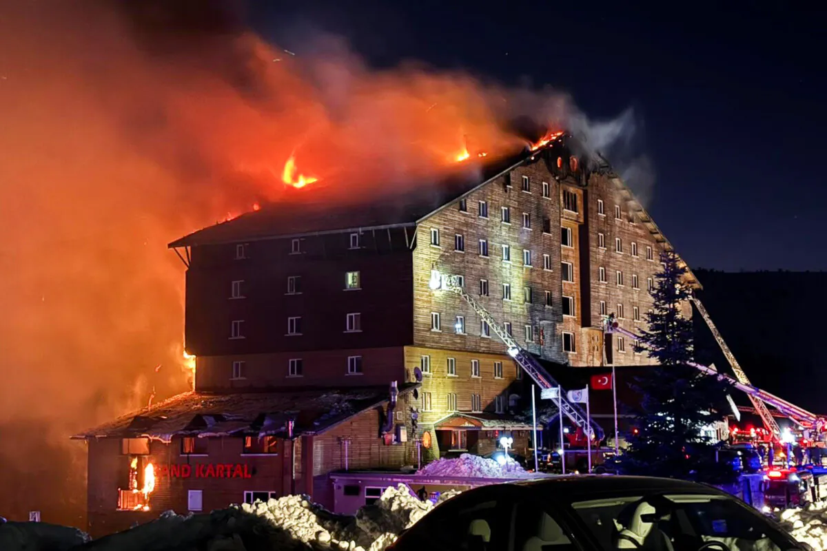 Firefighters work to extinguish a fire in a hotel at a ski resort of Kartalkaya in Bolu province, Turkey, on Jan. 21, 2025. (IHA via AP)