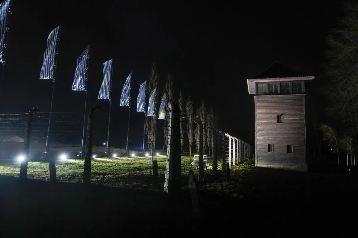 Flood lights illuminate a guard tower at the Birkenau Nazi death camp in Oswiecim, Poland, on Jan. 27, 2024. (The Canadian Press/AP-Czarek Sokolowski)