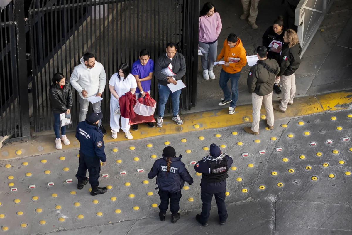 Mexican immigration officials and police receive deportees after they were sent back into Mexico on Jan. 22, 2025, as seen from Nogales, Ariz. (John Moore/Getty Images)