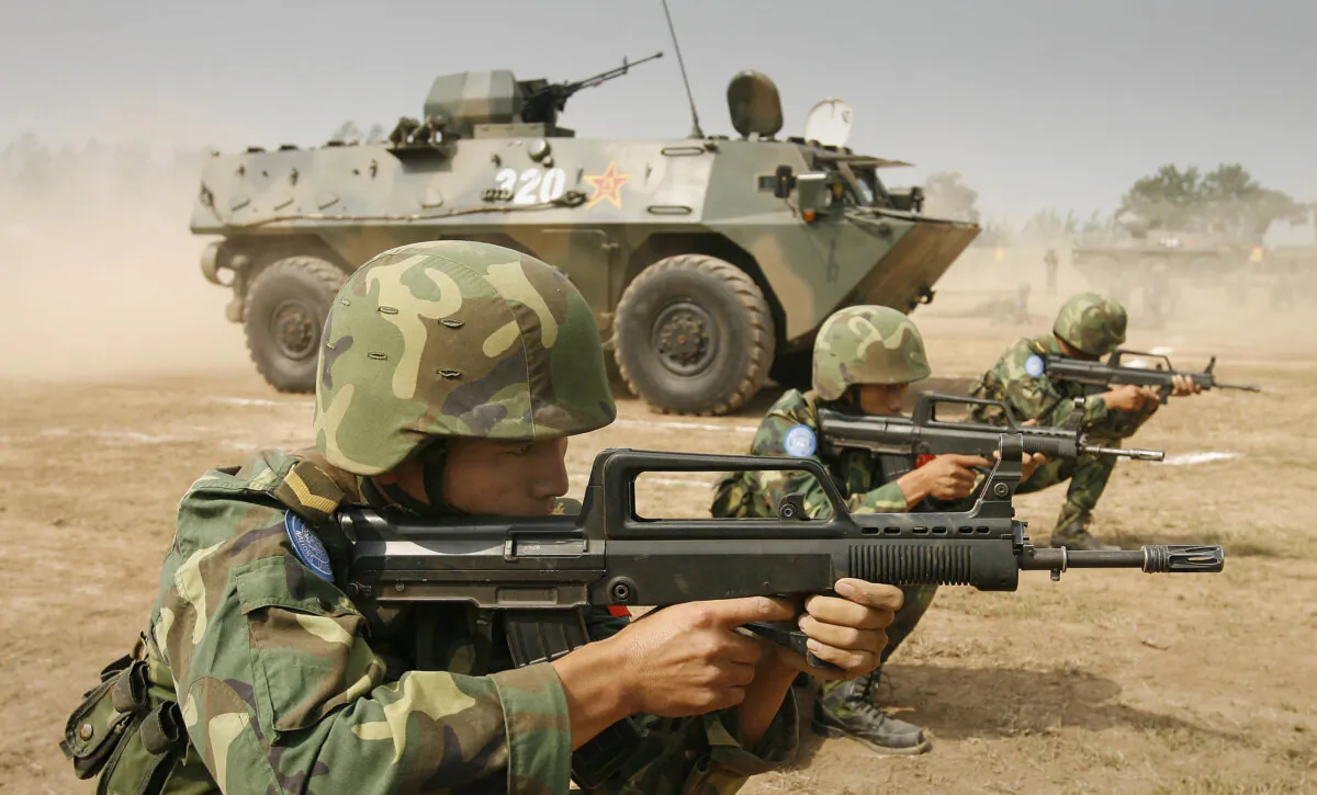 People's Liberation Army soldiers and members of a U.N. peacekeeping unit destined for Darfur in the Sudan practice defense maneuvers at their base in China's central Henan Province on Sept. 15, 2007. (PETER PARKS/AFP via Getty Images)