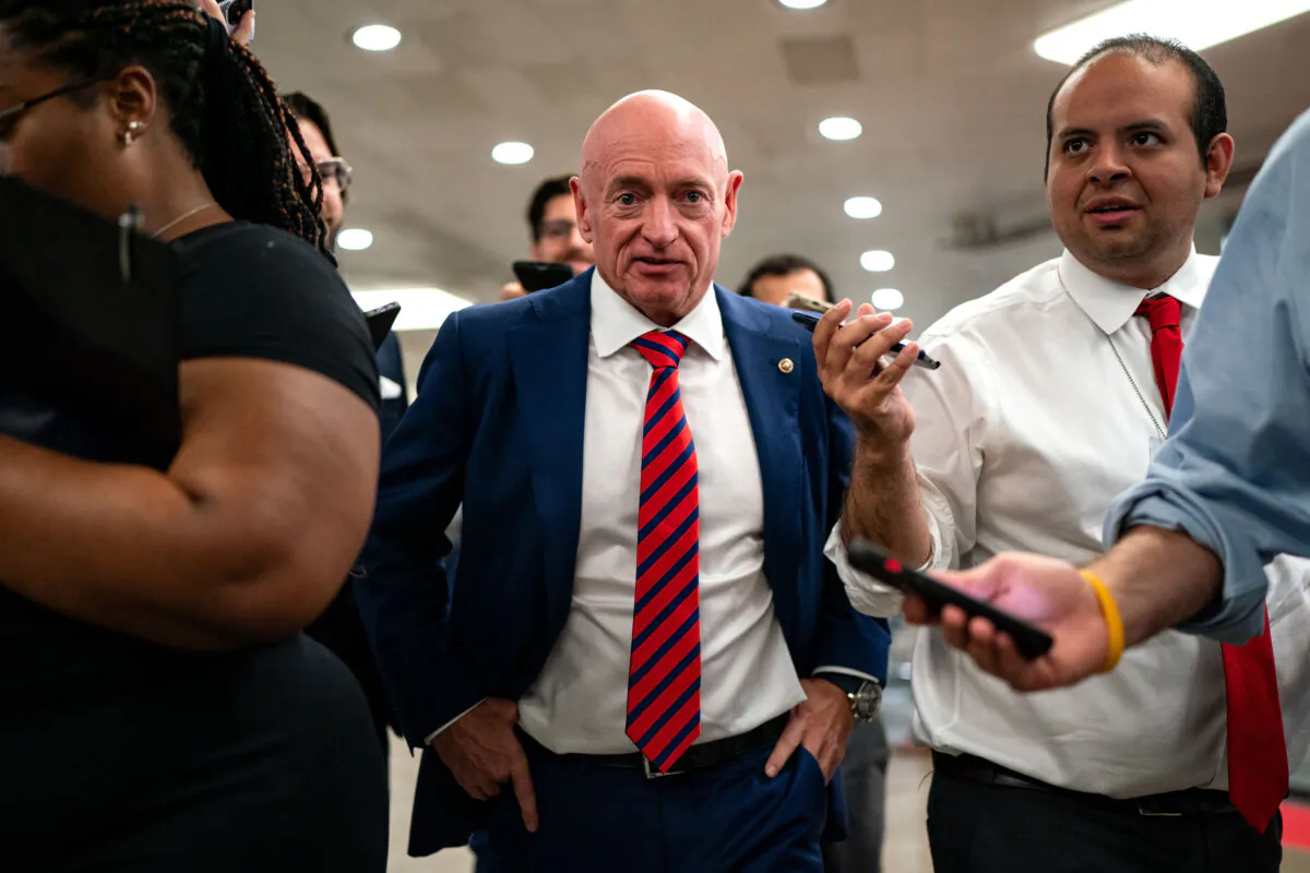 U.S. Sen. Mark Kelly (D-Ariz.) speaks with reporters while waiting to catch the Senate subway to the Hart Senate Office Building from the U.S. Capitol in Washington on July 25, 2024. (Kent Nishimura/Getty Images)