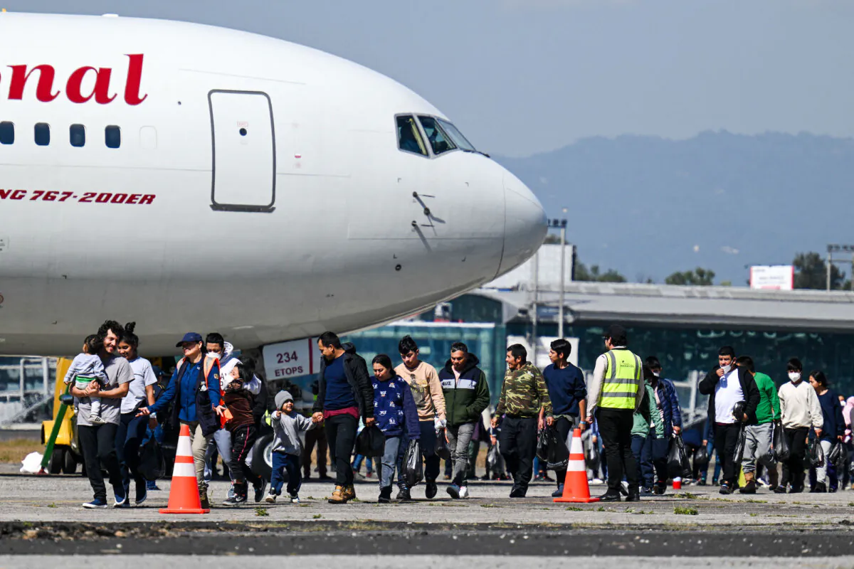 Guatemalan nationals deported from the United States walk on the tarmac after landing at the Air Force Base in Guatemala City in the first flight of deportees of the year, on Jan. 3, 2024. (Johan Ordonez/AFP via Getty Images)