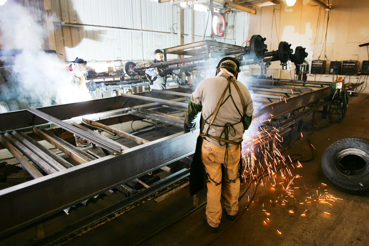 Employees work on a chassis at a factory in Riverside, Calif., on Sept. 23, 2005. (David McNew/Getty Images)