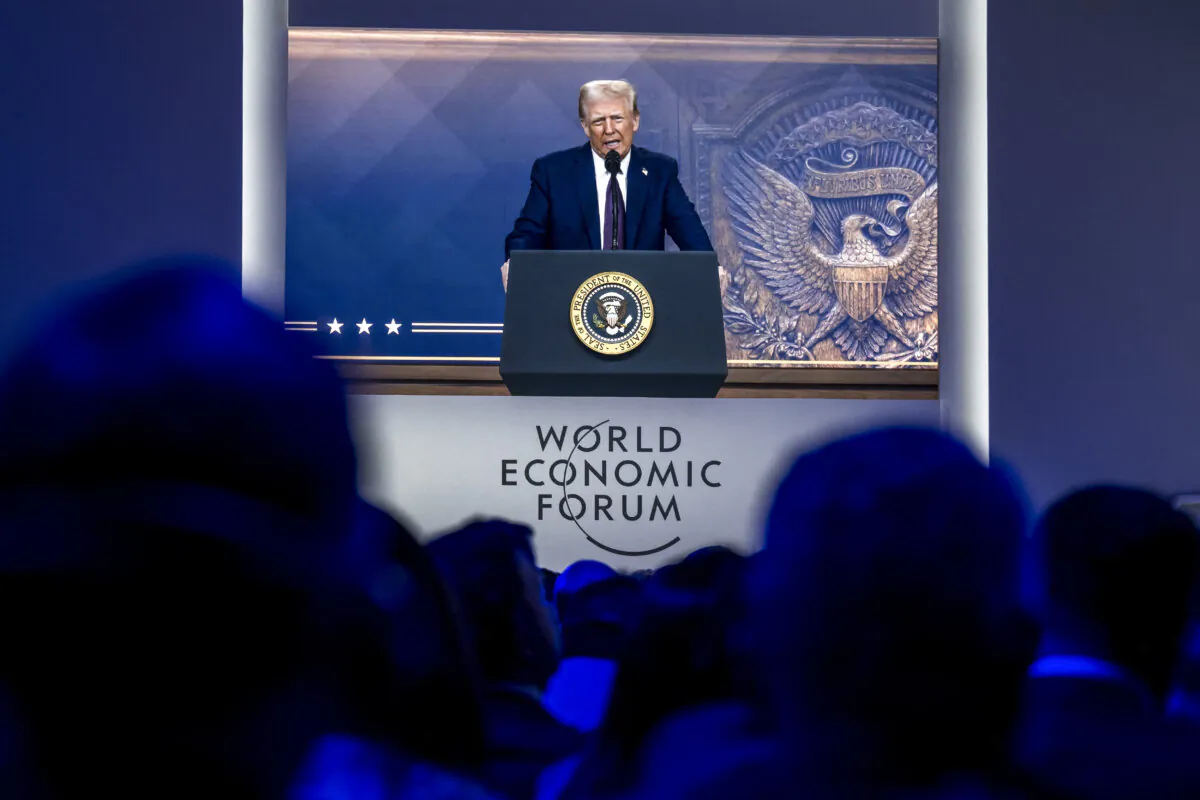 U.S. President Donald Trump is seen on a giant screen during his address by video conference at the World Economic Forum (WEF) annual meeting in Davos on Jan. 23, 2025. (Fabrice Coffrini/AFP via Getty Images)