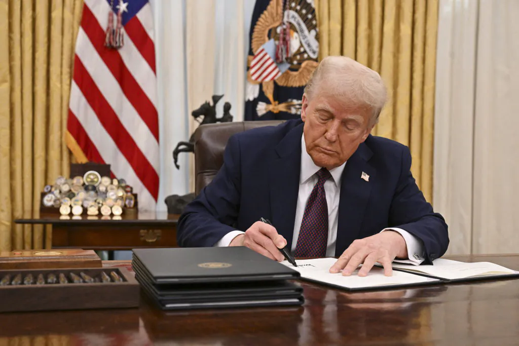 President Donald Trump signs an executive order to declassify files on the assassinations of President John F. Kennedy, Attorney General Robert F. Kennedy, and civil rights leader Martin Luther King Jr., in the Oval Office of the White House on Jan. 23, 2025. (Roberto Schmidt/AFP via Getty Images)