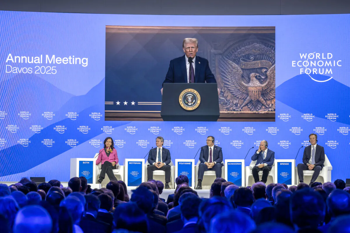 President Donald Trump appears on a giant screen as he addresses global elites via video conference at the World Economic Forum in Davos on Jan. 23, 2025. (Fabrice Coffrini/AFP via Getty Images)