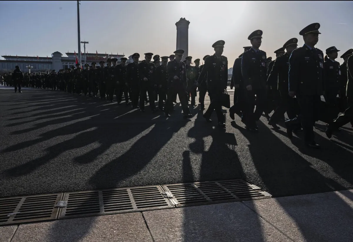 Chinese military delegates walk in a line as they arrive at the second plenary session of China's rubber-stamp legislature, the National People’s Congress, at the Great Hall of the People in Beijing on March 8, 2024. China's annual political gathering, known as the Two Sessions, convenes leaders and lawmakers to set the regime's agenda for domestic economic and social development for the year. (Kevin Frayer/Getty Images)