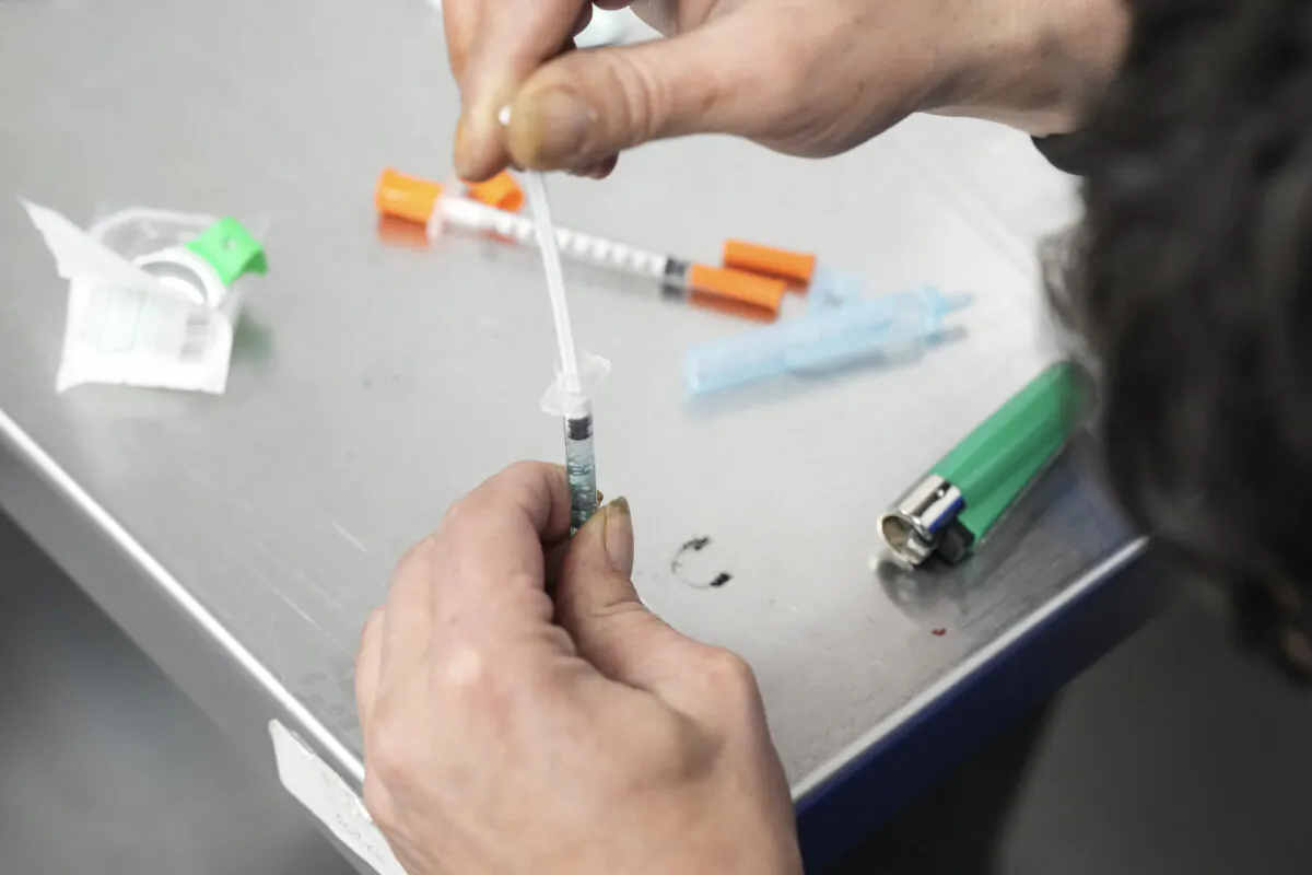 A client draws up fentanyl as he visits the consumption room at Moss Park Consumption and Treatment Service in Toronto, on Dec. 3, 2024. (The Canadian Press/Chris Young)