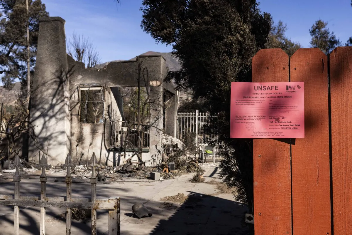 Signs labeling destroyed homes as "unsafe" are posted after the Eaton Fire in Altadena, Calif., on Jan. 24, 2025. (John Fredricks/The Epoch Times)