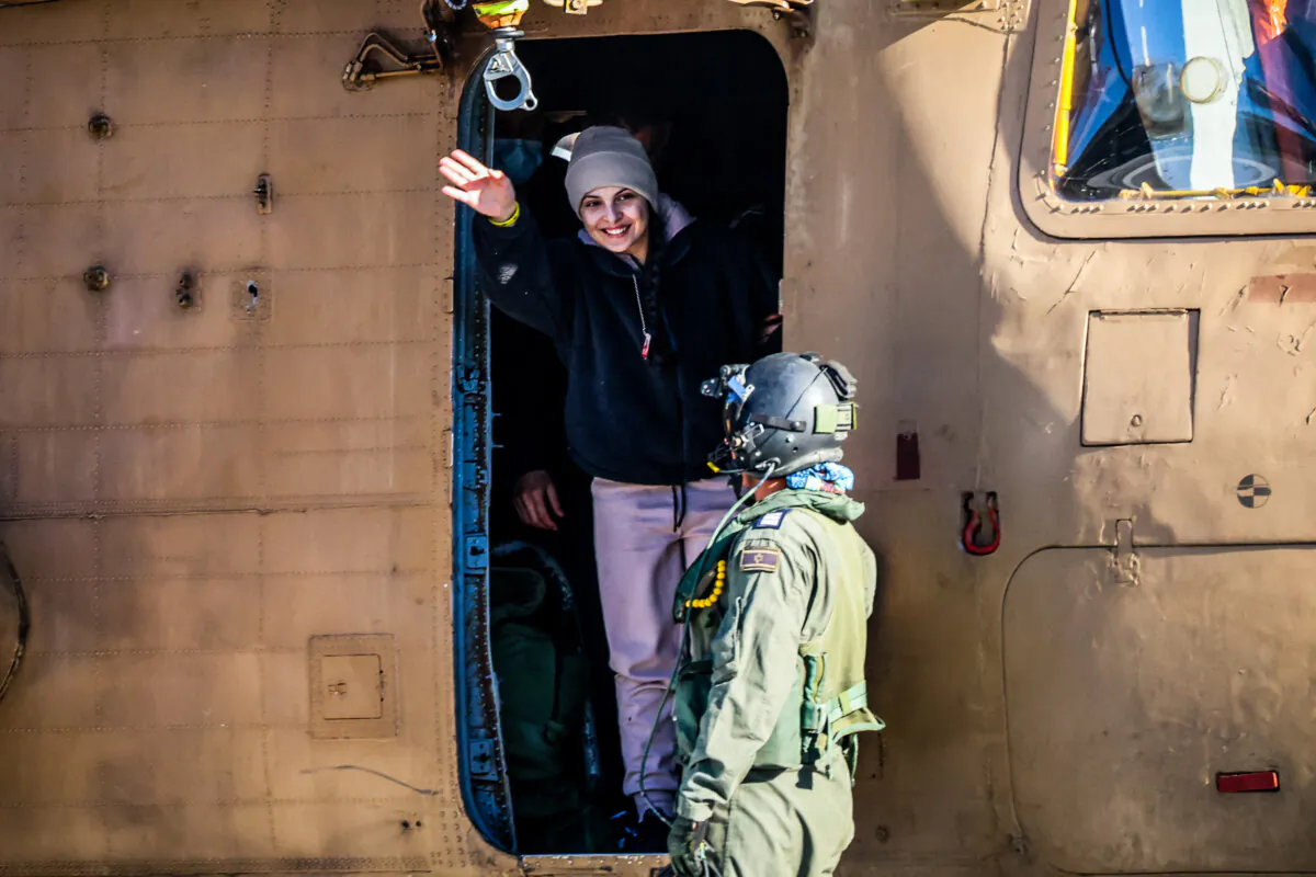 Newly released Israeli hostage Daniella Gilboa, waves as she leaves a military helicopter upon landing at the Beilinson Hospital in Petah Tikva, Israel, on Jan. 25, 2025. (Yossi Zamir/AFP via Getty Images)