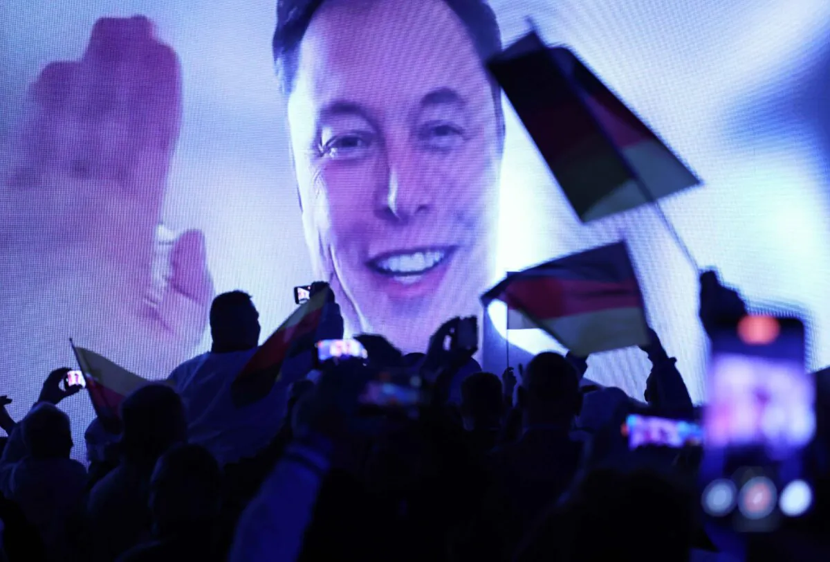 Tech billionaire Elon Musk speaks live via a video transmission during the election campaign launch rally of the far-right Alternative for Germany (AfD) political party as AfD supporters wave German flags in Halle, Germany on January 25, 2025 (Sean Gallup/Getty Images)