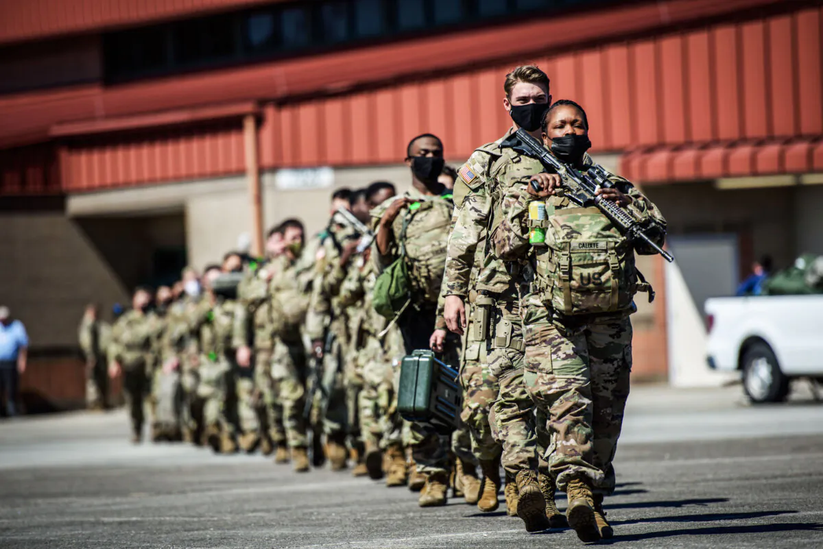 Members of the 1st Armored Brigade Combat Team, 3rd Battalion, 69th Armored Regiment deploy to Germany to reassure NATO allies from their base in Savannah, Ga., on March 2, 2022. (Melissa Sue Gerrits/Getty Images)