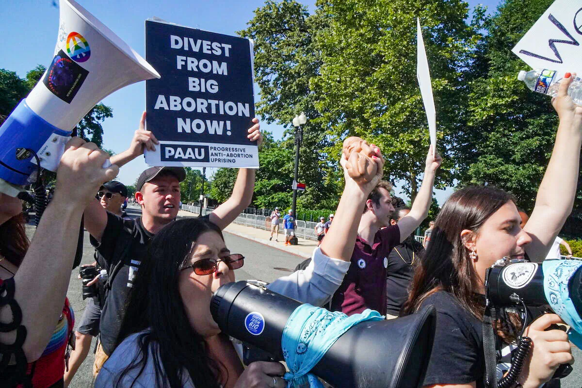 Left-wing pro-life protesters with Progressive Anti-Abortion Uprising protest outside the U.S. Supreme Court on June 15, 2022.(Jackson Elliott/The Epoch Times)