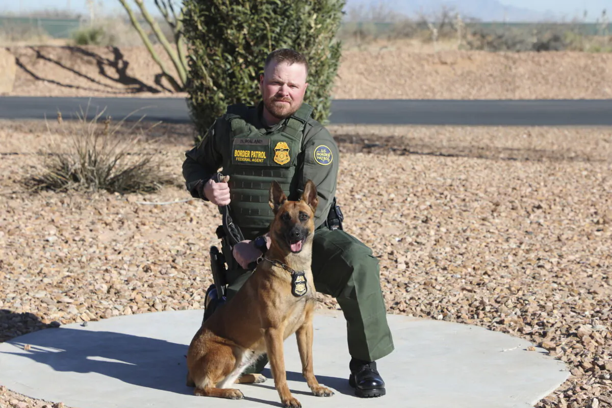 Border Patrol Agent David Maland poses with a service dog in a file photo. (Department of Homeland Security via AP)