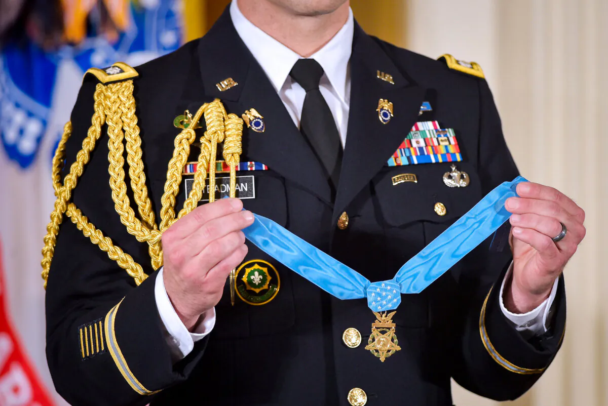 A military aide holds the Medal of Honor during a presentation ceremony in the East Room of the White House on July 18, 2016. (Mandel Ngan/AFP via Getty Images)