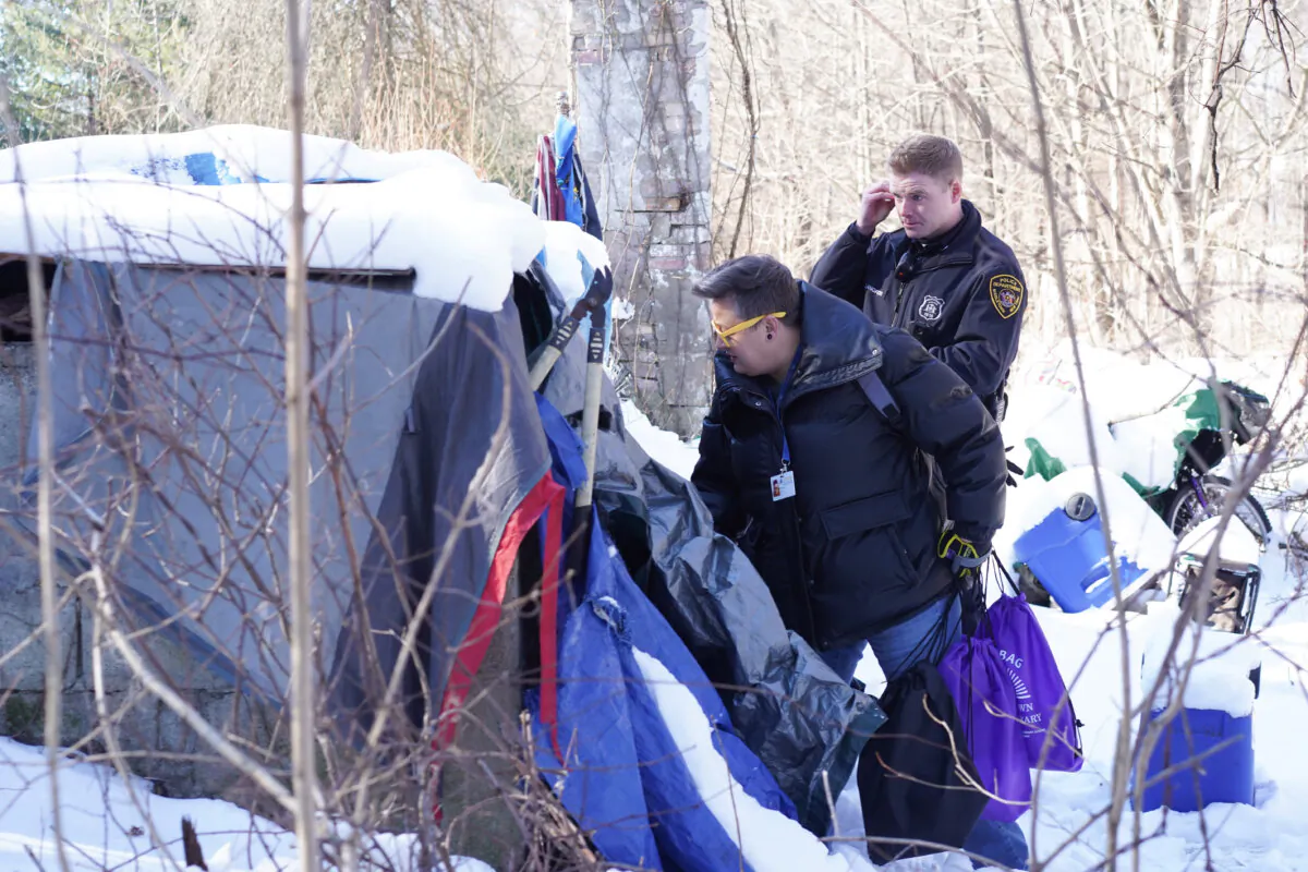 Clinician Patricia Moore and police officer Nicholas Langford check out an outdoor encampment during an annual national homeless tally in Middletown, N.Y., on Jan. 23, 2025. (Cara Ding/The Epoch Times)