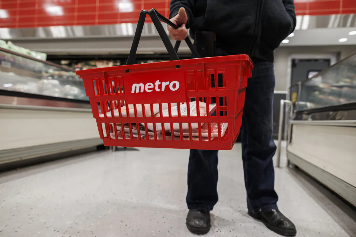 A customer holds a shopping basket at a Metro grocery store In Toronto on Feb. 2, 2024. (The Canadian Press/Cole Burston) 